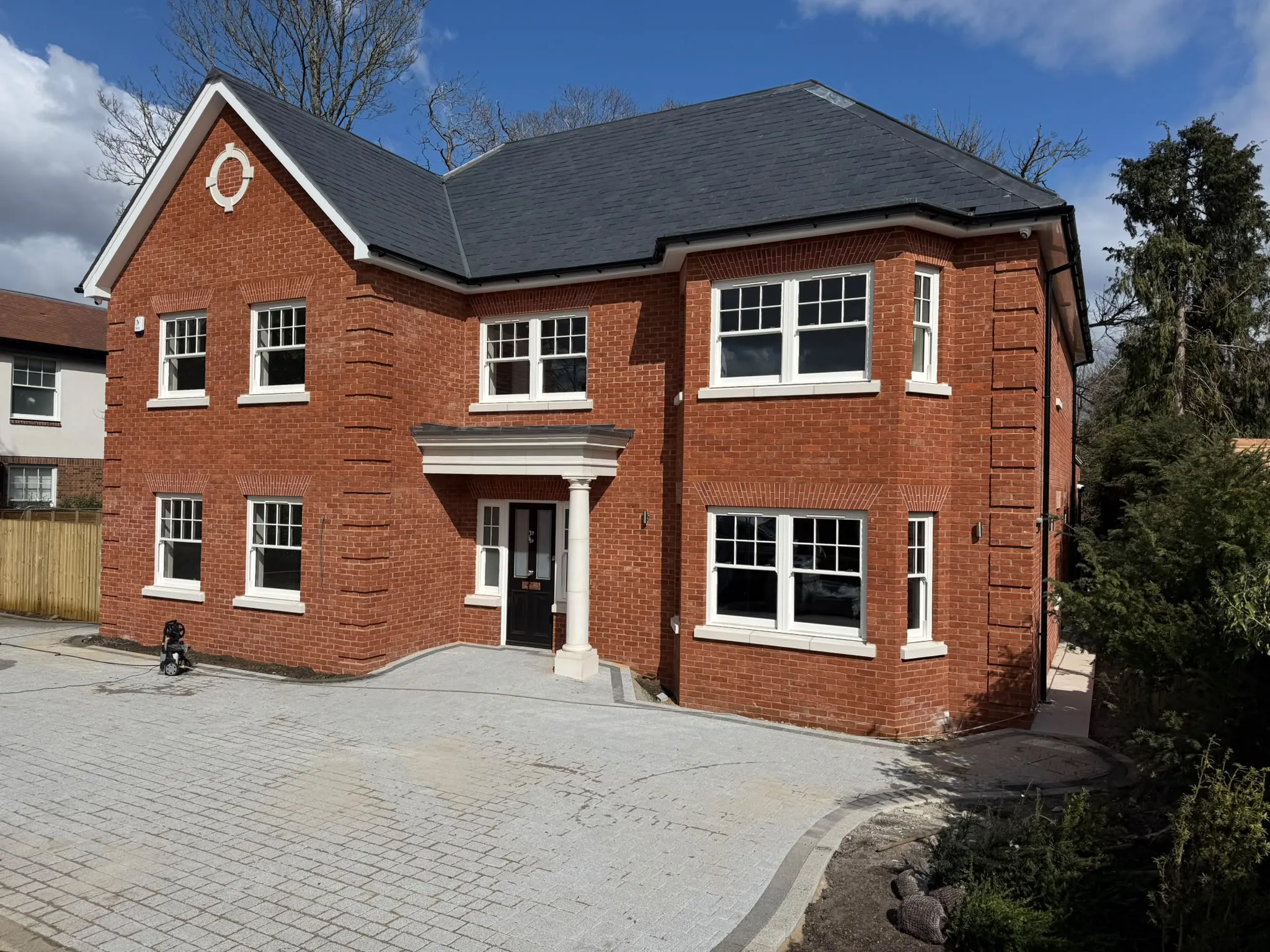 Block paving driveway to a large red brick detached home by Prestige Landscapes